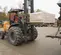 Front angled view of an orange CASE forklift with large tires, lifting a pallet with an operator on an outdoor worksite.