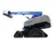 Side view of an extended blue and gray Genie boom lift with elevated platform and tracks.