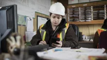 person in hard hat at desk