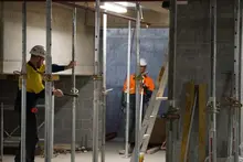 Workers installing temporary support props at a construction site to ensure structural safety and stability.