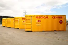 Stacked storage containers at a construction or logistics site, organized and ready for deployment or repurposing.