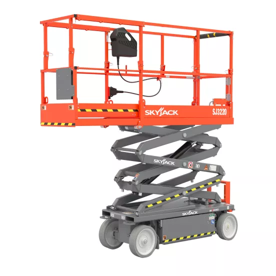 Side angled view of a retracted orange Skyjack scissor lift with safety rails.